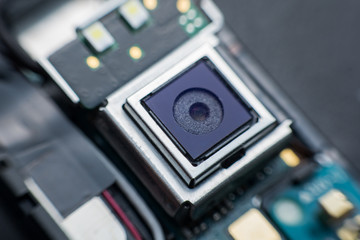 Obraz premium Close up camera inside electronic circuit board smart phone. disassembled cell phone parts.