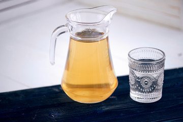 The carafe of juice on a white background
