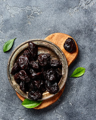 Dried prunes on plate. Top view of peeled plums. Top view.