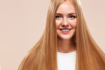 Beautiful Blonde Woman Beauty Model Girl with perfect makeup and long straight hair on light copyspace