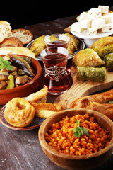 Middle eastern or arabic dishes and assorted meze, concrete rustic background. sambusak. Turkish Dessert Baklava with pistachio. Sarma. Halal food. Lebanese