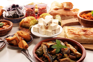 Middle eastern or arabic dishes and assorted meze, concrete rustic background. sambusak. Turkish Dessert Baklava with pistachio. Sarma. Halal food. Lebanese