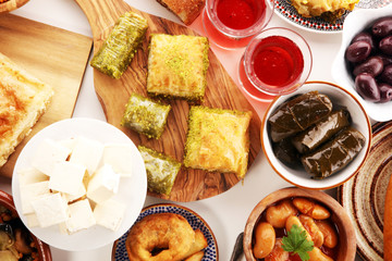 Middle eastern or arabic dishes and assorted meze, concrete rustic background. sambusak. Turkish Dessert Baklava with pistachio. Sarma. Halal food. Lebanese