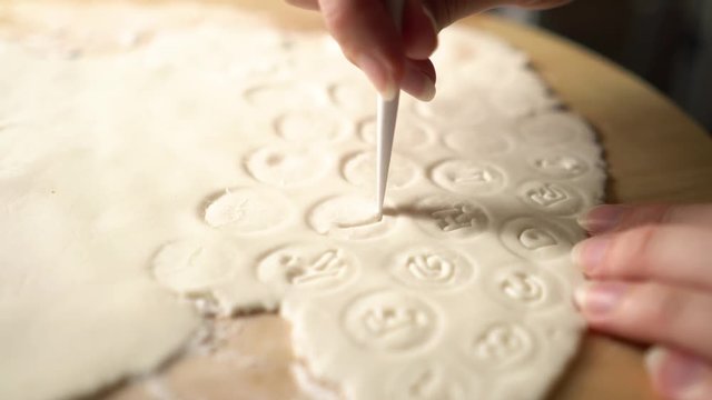 Closeup of Woman hands cutting letters from sugar marzipan fondant icing