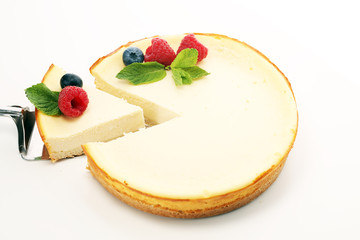 Homemade cheesecake with fresh raspberries and mint for dessert - healthy organic summer dessert...