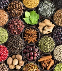 Tuinposter bright  spices and herbs in cups, top view. background for packing with European condiments. © dmitr1ch