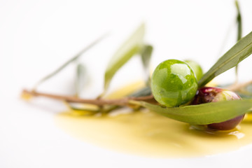 Three olives and olive oils with leaves