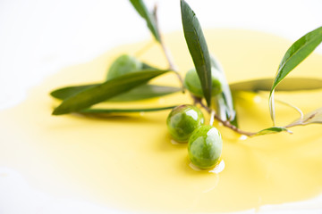 Three olives and olive oils with leaves