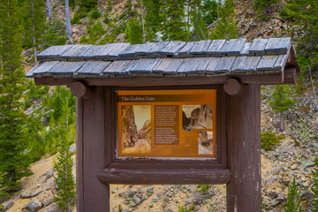 Yellowstone's Grand Loop Road passes through the Golden Gate surrounded by steep and colorful volcanic rocky walls.