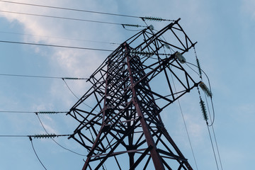 Electrical tower on a background of the blue sky. Metal electric pole. Electrical powerlines. Safe...