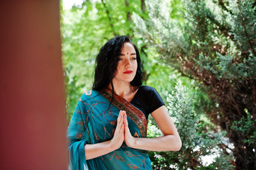 Naklejka premium Portrait of beautiful indian brumette girl or hindu woman model. Traditional Indian costume lehenga choli.