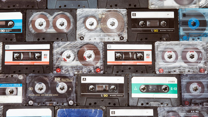 Vintage audio cassette on a wooden background. Collection of various retro audio tapes 