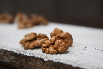 Nut isolated on a white wooden background. Healthy food. Rustc style.
