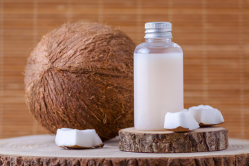 Obraz na płótnie Canvas cosmetic bottle and fresh organic coconut , natural background