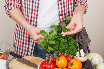 Woman cooks on the kitchen, soft focus background