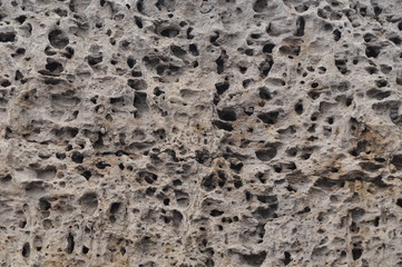 Background texture porous stone wall closeup