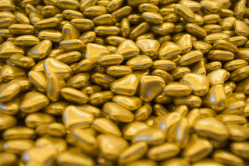 Gold hearts texture. Golden valentine day background.