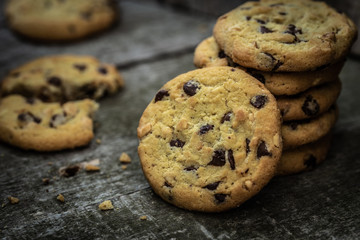 Rounded chocolate cookies on natural old desk.
