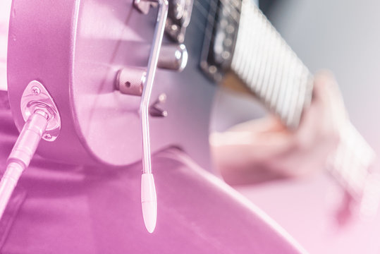 Close up of man playing on electric guitar