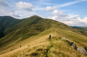 girl with a big backpack rises to the mountains. Ukraine