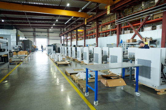 Wide angle shot of empty factory workshop with machines ready for assembling, copy space