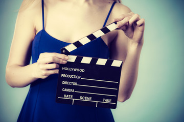 Woman holding professional film slate