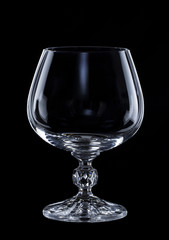 empty glass for cognac isolated over black background