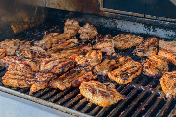 Piece of pork meat is baked on the grill