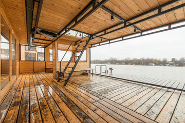 Wooden terrace of cottage near river