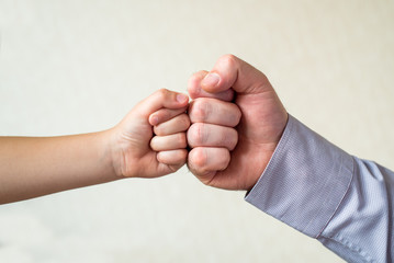 competition and victory, a fist of a child and an adult male close-up. Leader and winner