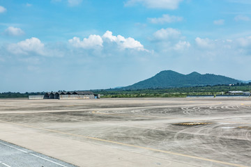 Landscape, empty wide runway with the hills and blue sky background.