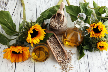 Sunflower oil, sunflower and seeds on white background