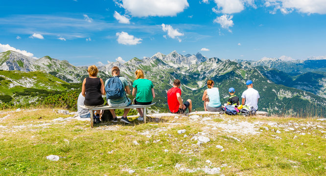 Young Family On Top Of Mountain Is Looking To Far Hill. Slovenia Mountain Vogel, Triglav And Near Bohinj Lake.