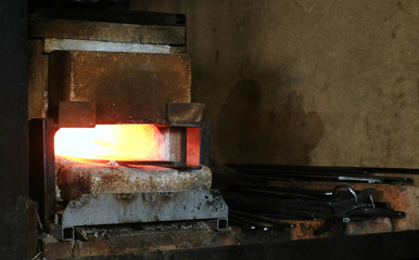 Making the sword out of metal at the forge.Hot metal billets in the furnace.