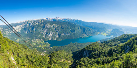 Fototapeta na wymiar Aerial view of Bohinj lake from Vogel cable car station. Mountains of Slovenia in Triglav national park. Julian alps landscape. Blue water, summer sky, mountains in the bakcground