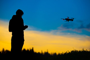 Fototapeta na wymiar Drone operator and drone silhouette