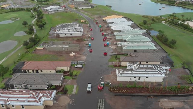 A pickup truck driving through a South Florida flooded street