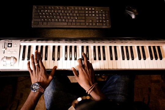 African man plays jazz on musical synthesizer