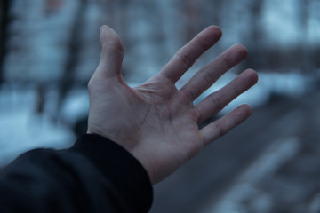 Obraz premium Hand in the cold.Blurred background