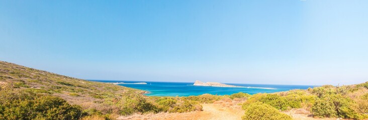 Fototapeta premium Beautiful bay with turquoise water. A popular tourist beach. Kolokitha beach. Peninsula Kalydon. Crete, Elounda,Greece.Panoramic view HD.