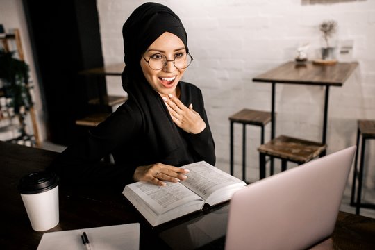 Muslim Hijab Girl Working In Office At Laptop Reading Book