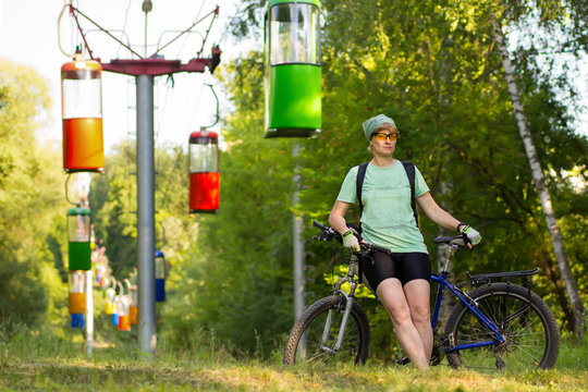 Adult woman standing with a bicycle