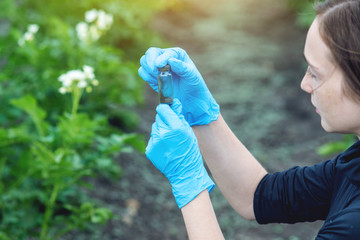 Agronomist woman holding a soil sample and a tablet. Concept environmentally friendly farm...
