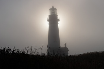 sunset silhouette at cape foulweather lighthouse at yaquina outstanding natural area in newport...