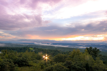 Fog lifts from the Kittany Mountains at sunset at High Point State Park, the top of NJ, in mid...