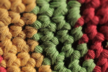 colorful background - macro photography of knitted wool structure in red, yellow and green