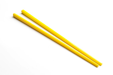 Yellow chopsticks isolated on white