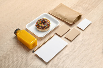 Composition with items for mock up design on wooden background. Food delivery service