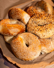 Fototapeta na wymiar Variety of assorted authentic New York style Bagels with seeds in a brown paper bag.