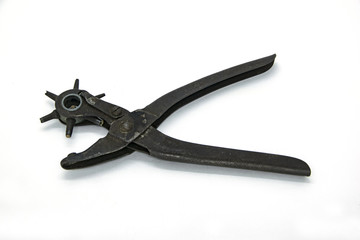 Equipment tool to pierce leather belt isolated in white background